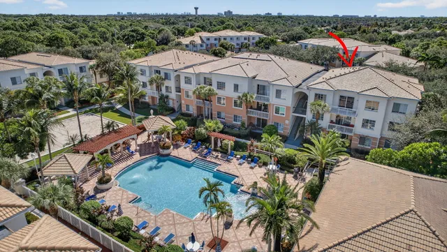 a view of empty room with wooden floor and window