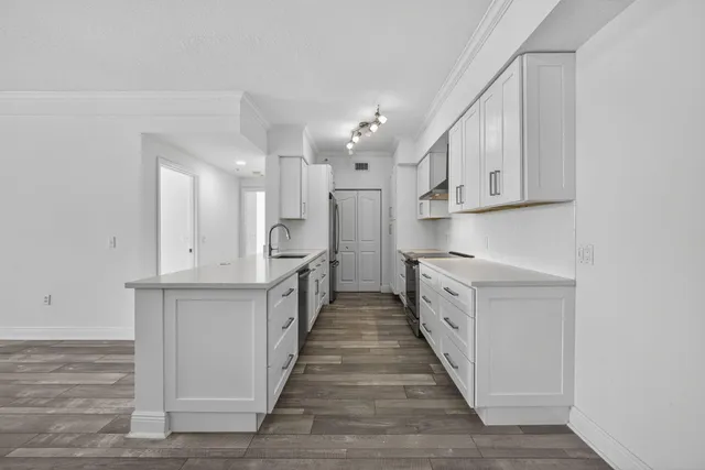 a dining room with furniture a chandelier and wooden floor