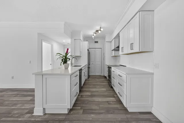 a kitchen with stainless steel appliances granite countertop a sink and cabinets