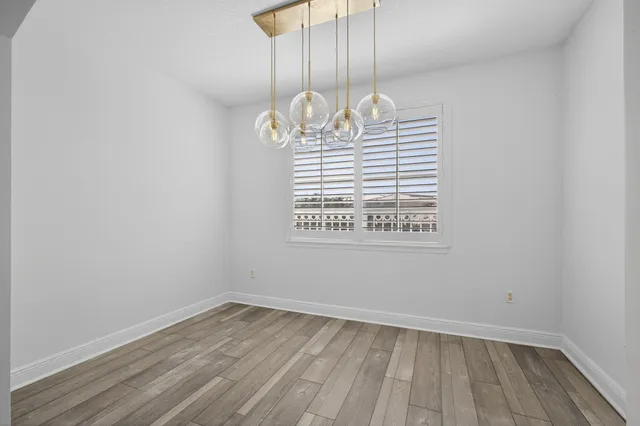 a bathroom with a granite countertop sink a toilet mirror and bathtub