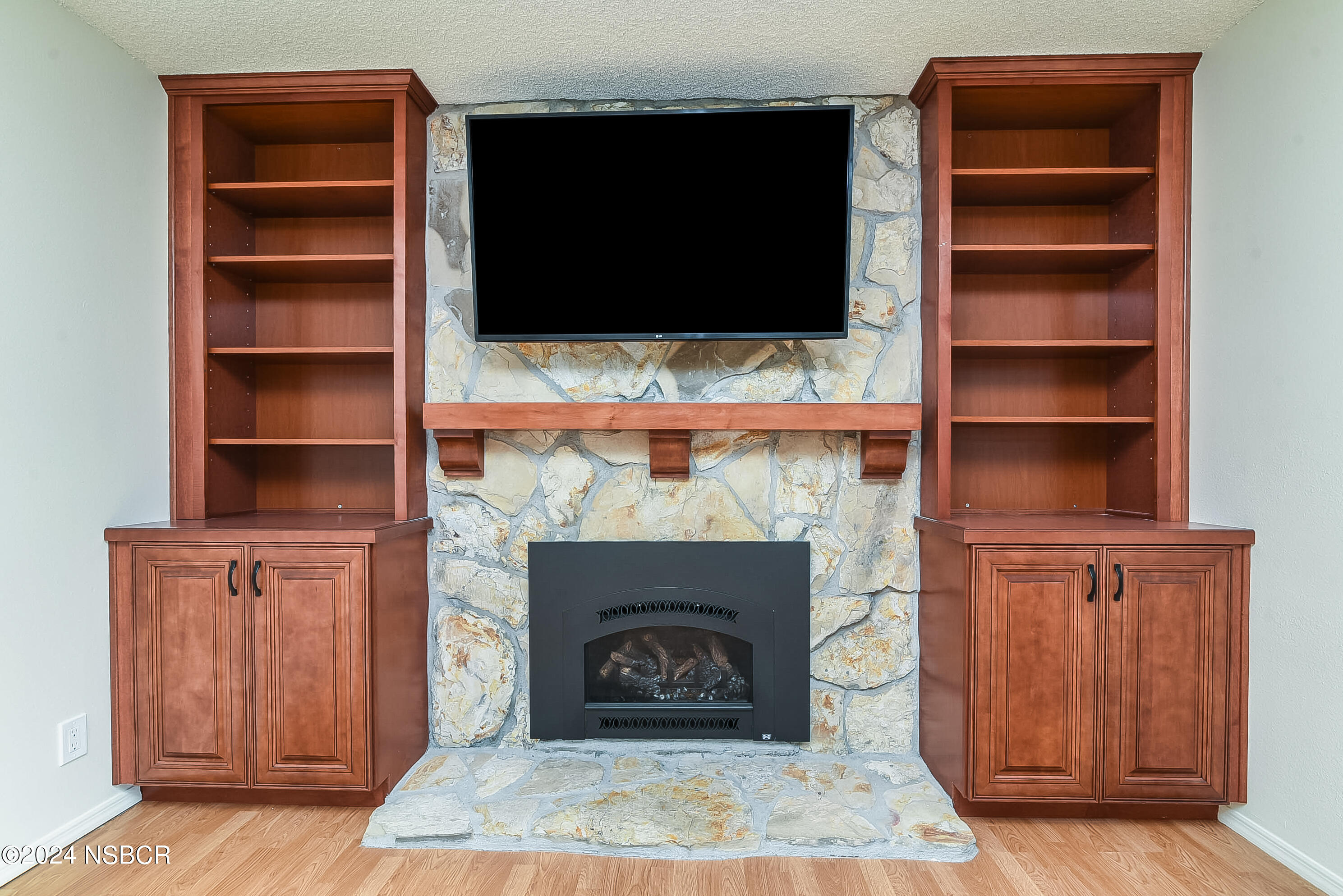 4487 Sirius Avenue Lompoc, CA 93436 - Photo 10 of 32 a living room with a fireplace and a walk in closet