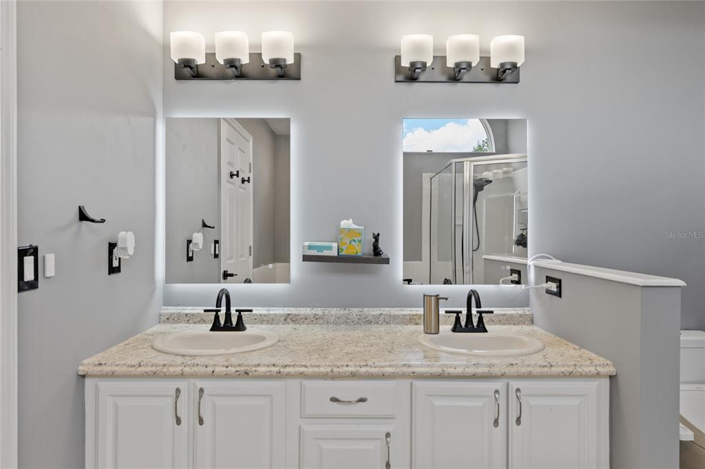 7637 Southwest 49th Place Gainesville, FL 32608 - Photo 19 of 47 a bathroom with a sink and a mirror