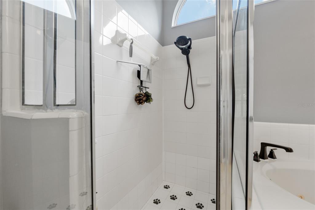 7637 Southwest 49th Place Gainesville, FL 32608 - Photo 22 of 47 a bathroom with a glass shower door