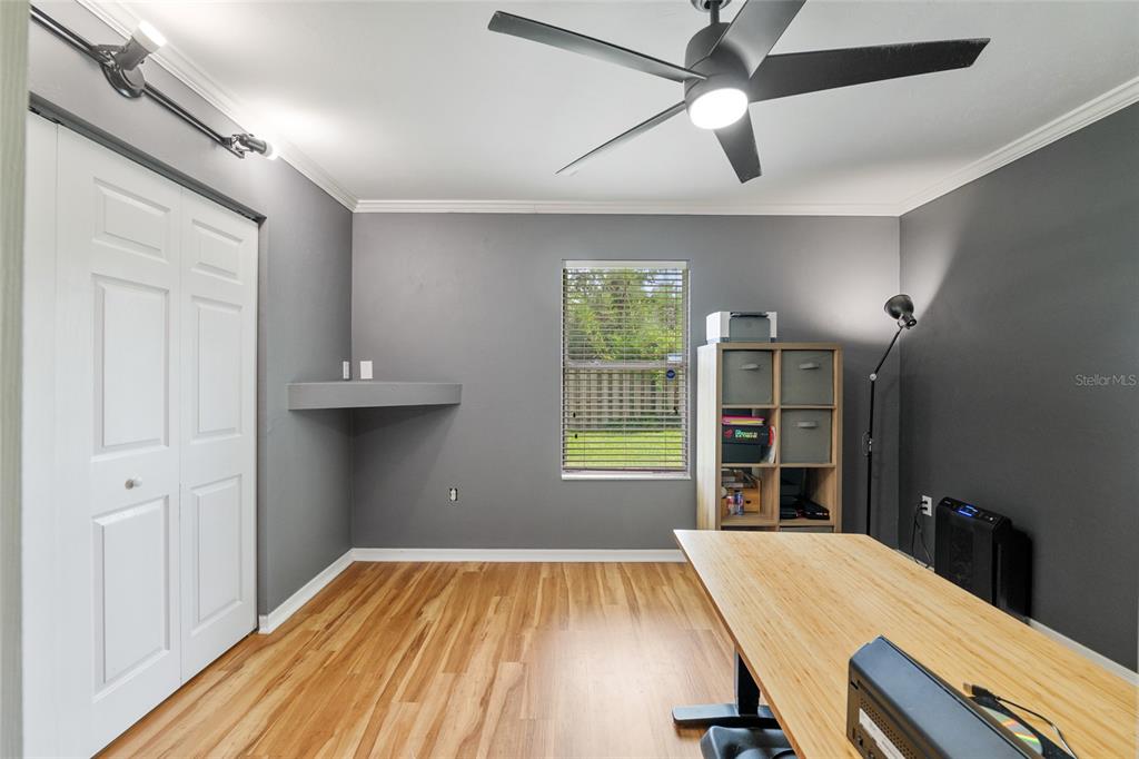 7637 Southwest 49th Place Gainesville, FL 32608 - Photo 24 of 47 wooden floor in an empty room with a window