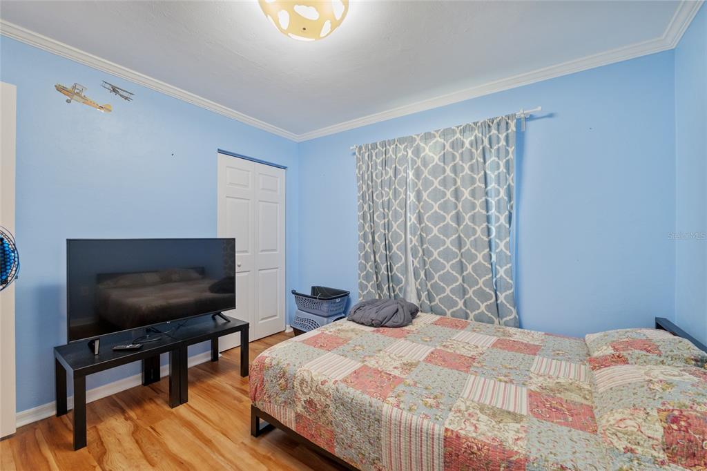 7637 Southwest 49th Place Gainesville, FL 32608 - Photo 28 of 47 a bedroom with a bed and a flat screen tv