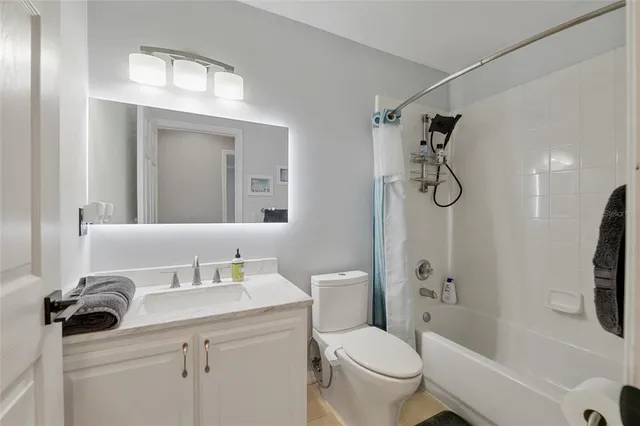 a bathroom with a sink toilet tub and shower