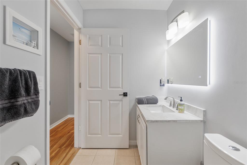 7637 Southwest 49th Place Gainesville, FL 32608 - Photo 30 of 47 a bathroom with a sink and a mirror