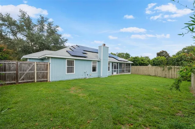 a view of a house with a yard and sitting area