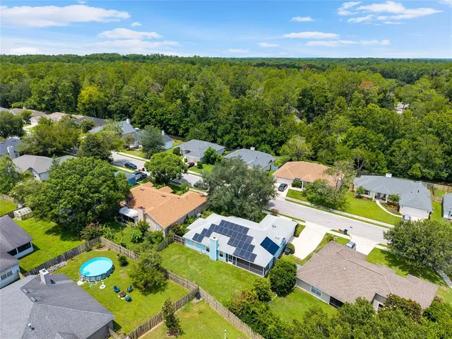 an aerial view of residential houses with outdoor space and street view