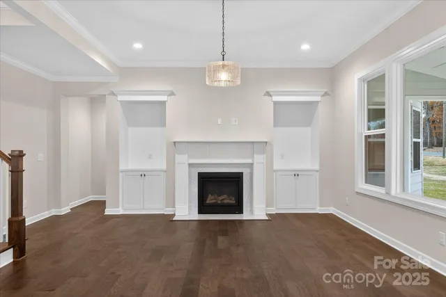 a view of a room with wooden floor and white walls