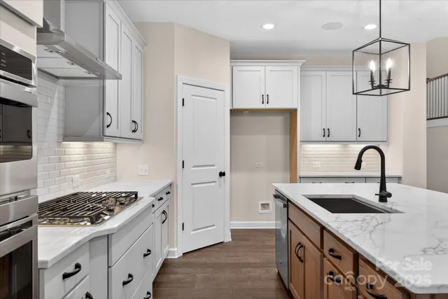 a view of empty room with wooden floor and window