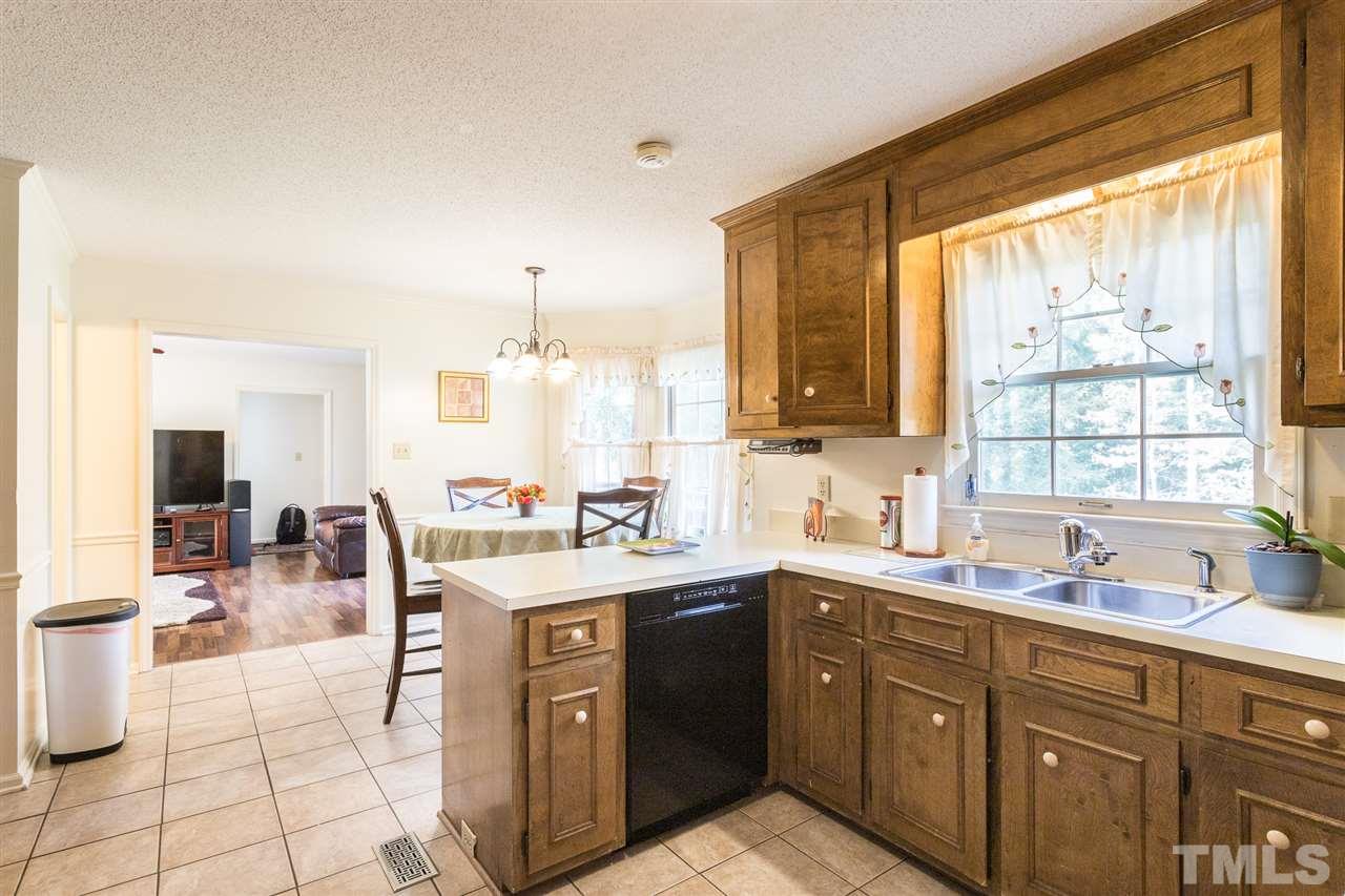 5363 Russell Road Durham, NC 27712 - Photo 14 of 28 a kitchen with a sink stove and cabinets