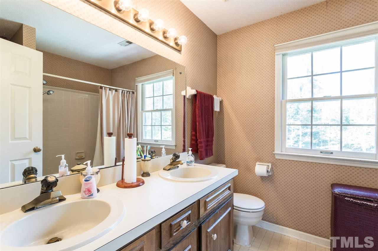 5363 Russell Road Durham, NC 27712 - Photo 20 of 28 a bathroom with a sink and a mirror