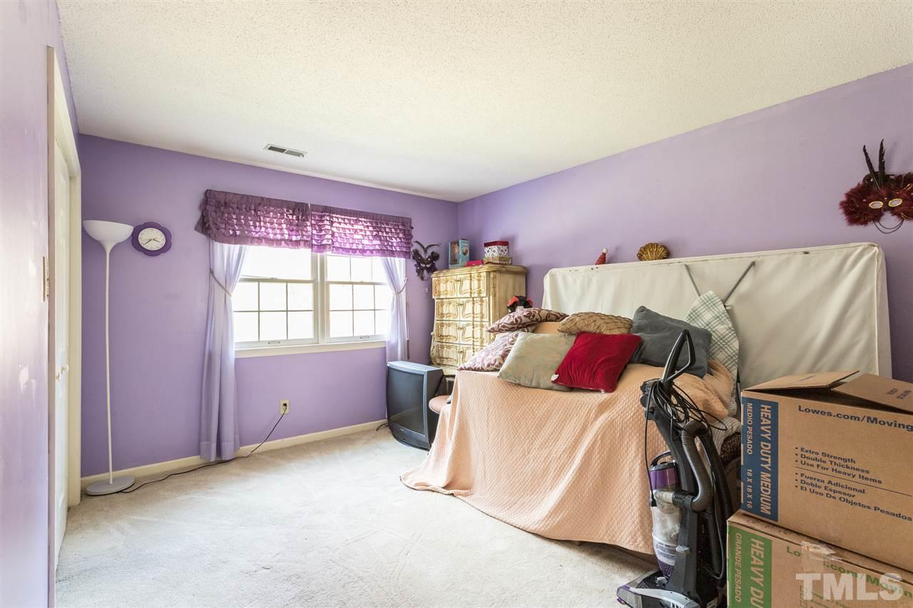 5363 Russell Road Durham, NC 27712 - Photo 22 of 28 a bed room with a bed and a window