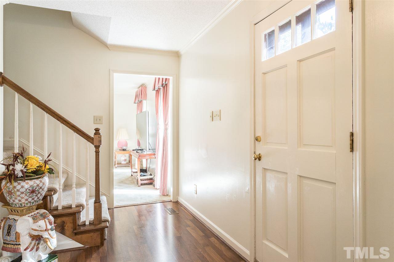5363 Russell Road Durham, NC 27712 - Photo 5 of 28 a view of a hallway with wooden floor and furniture