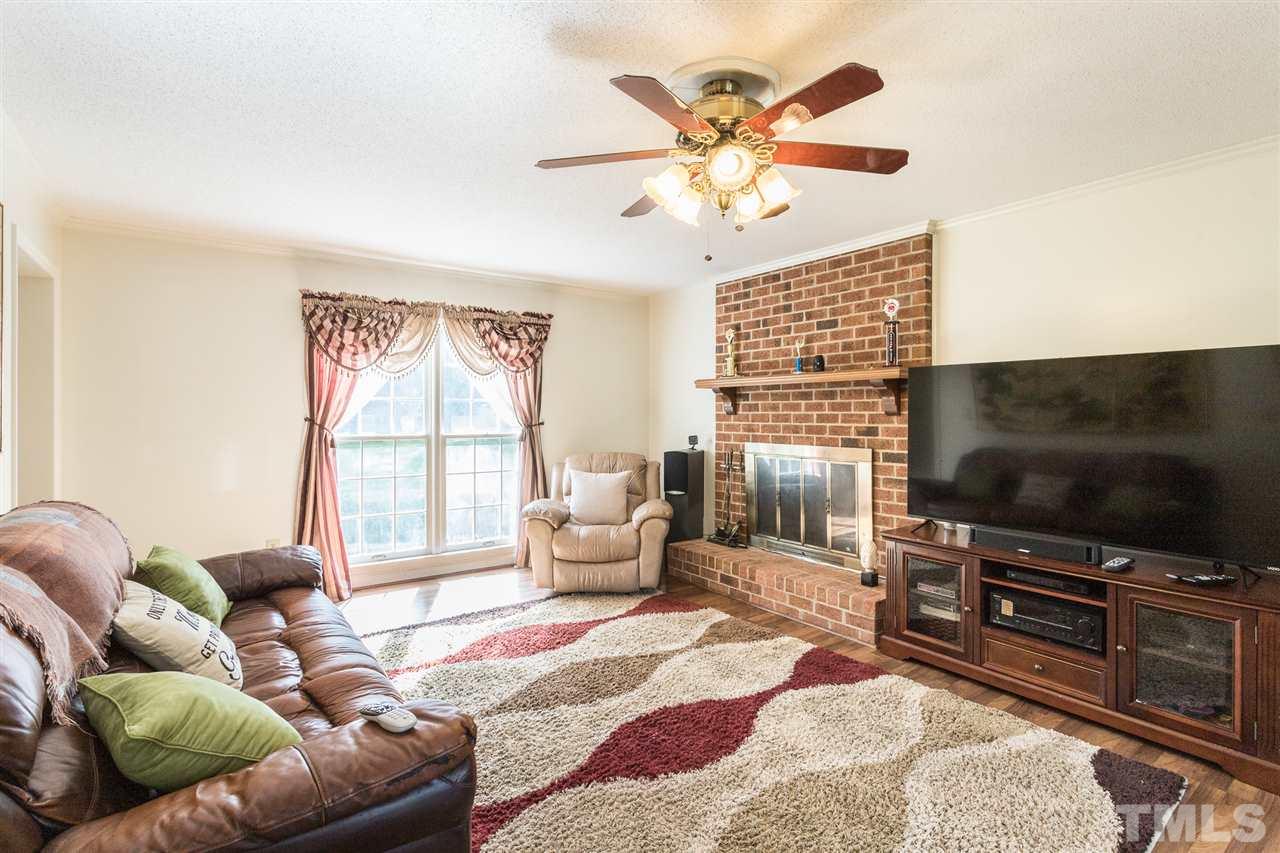 5363 Russell Road Durham, NC 27712 - Photo 9 of 28 a living room with furniture a flat screen tv and a large window