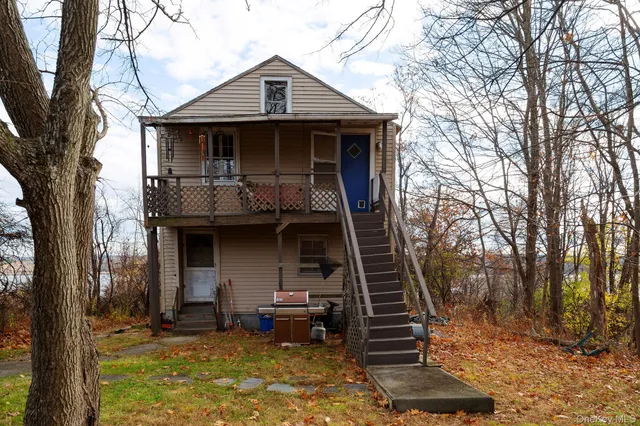a front view of a house with stairs