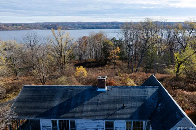 a view of a house with a yard and wooden fence