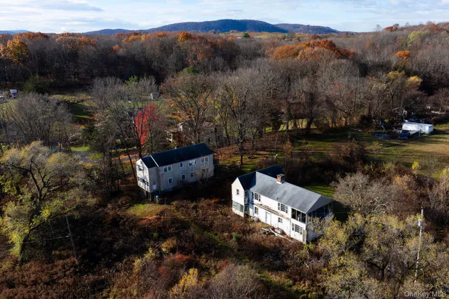 a bird view of house next to a city