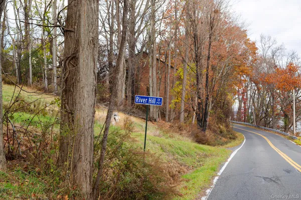 a sign board with tall trees