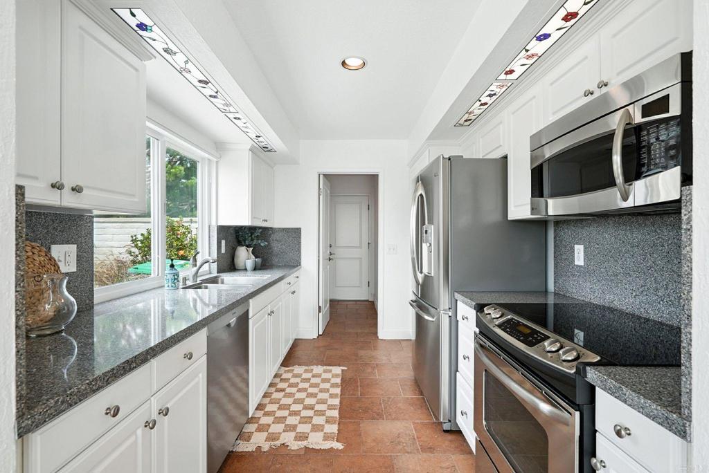 33611 Flying Jib Drive Dana Point, CA 92629 - Photo 13 of 28 a kitchen with stainless steel appliances kitchen island granite countertop a stove and a sink
