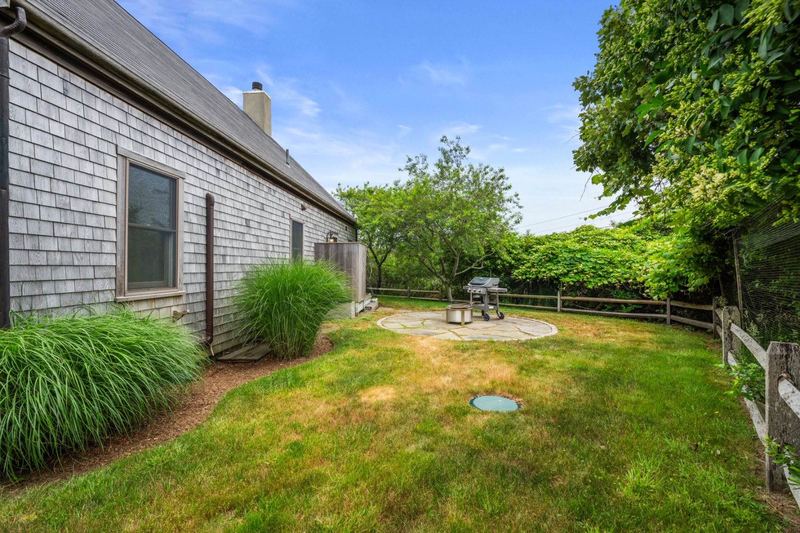 4 Berkley Street Nantucket, MA 02554 - Photo 47 of 47 a view of a backyard with plants and large tree