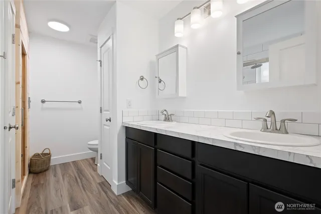a bathroom with a double vanity sink and mirror
