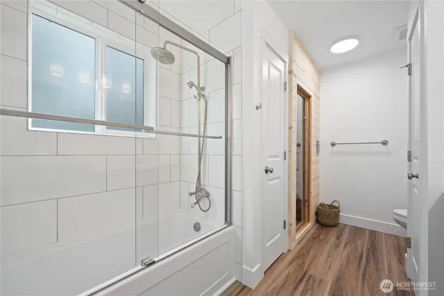 a bathroom with a shower and a glass door