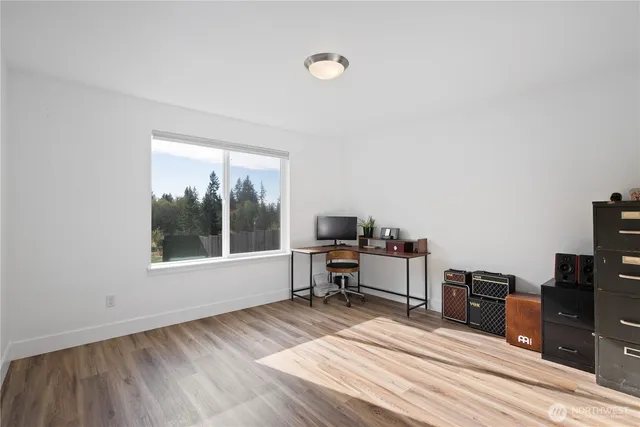 a view of a workspace with furniture and a window