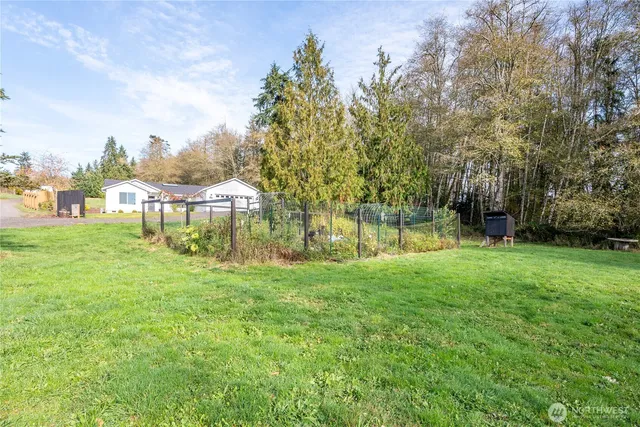 a view of a house with a yard and a garage