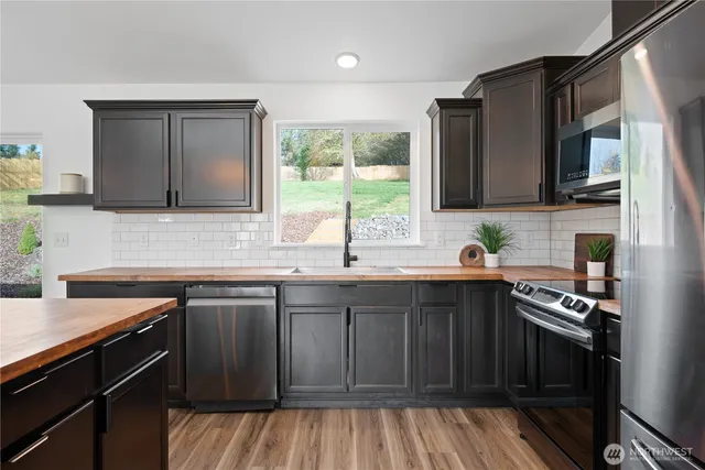 a kitchen with a sink stove top oven and cabinets