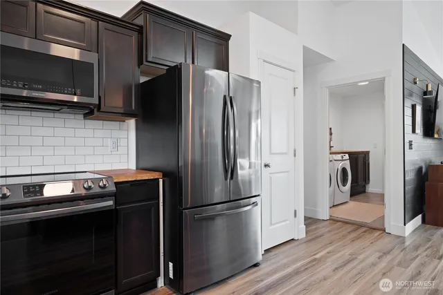 a metallic refrigerator freezer sitting in a kitchen