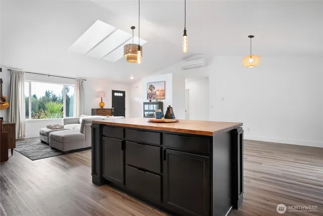 a kitchen with living room and window
