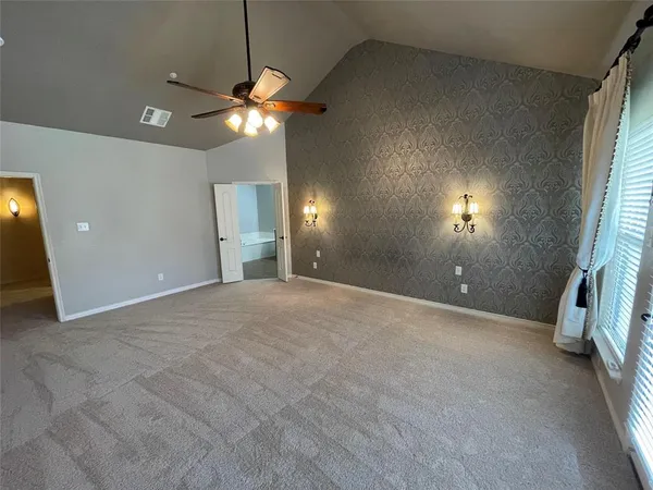 a view of a livingroom with a ceiling fan and window