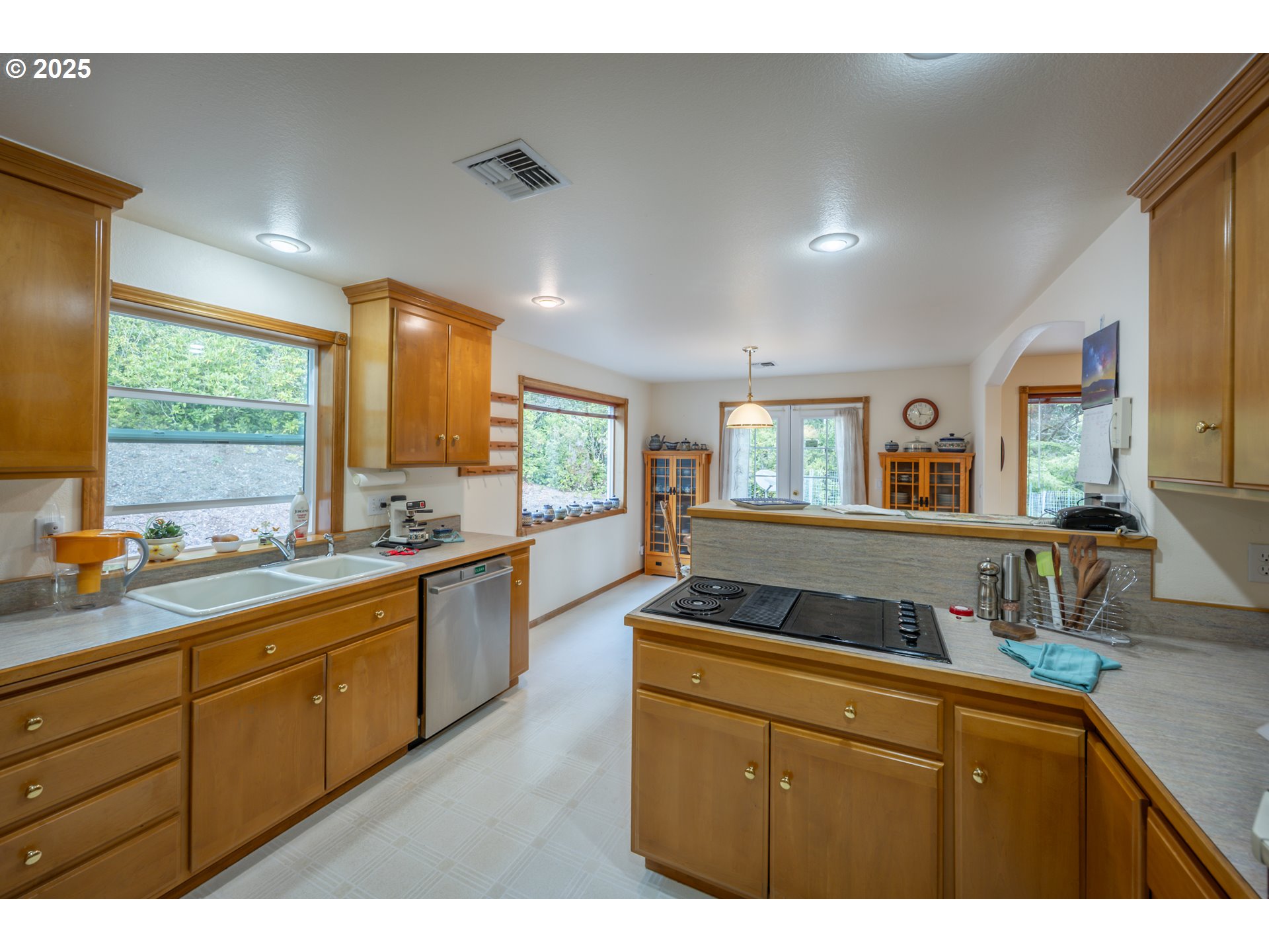 2184 13th Street Florence, OR 97439 - Photo 20 of 44 a kitchen with granite countertop a sink and cabinets