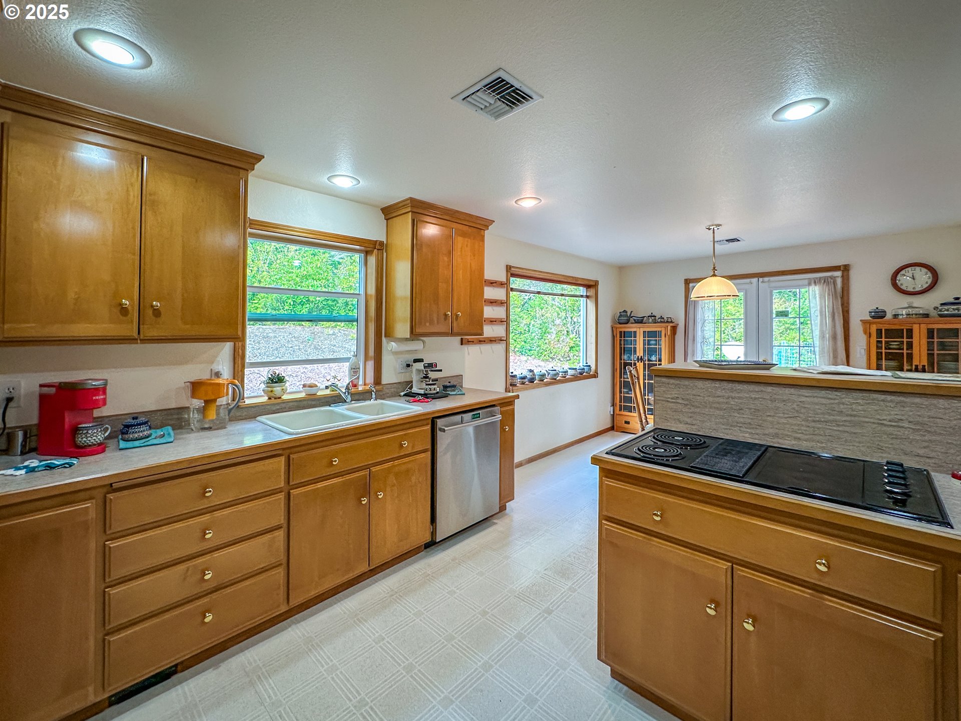 2184 13th Street Florence, OR 97439 - Photo 21 of 44 a kitchen with sink window and cabinets