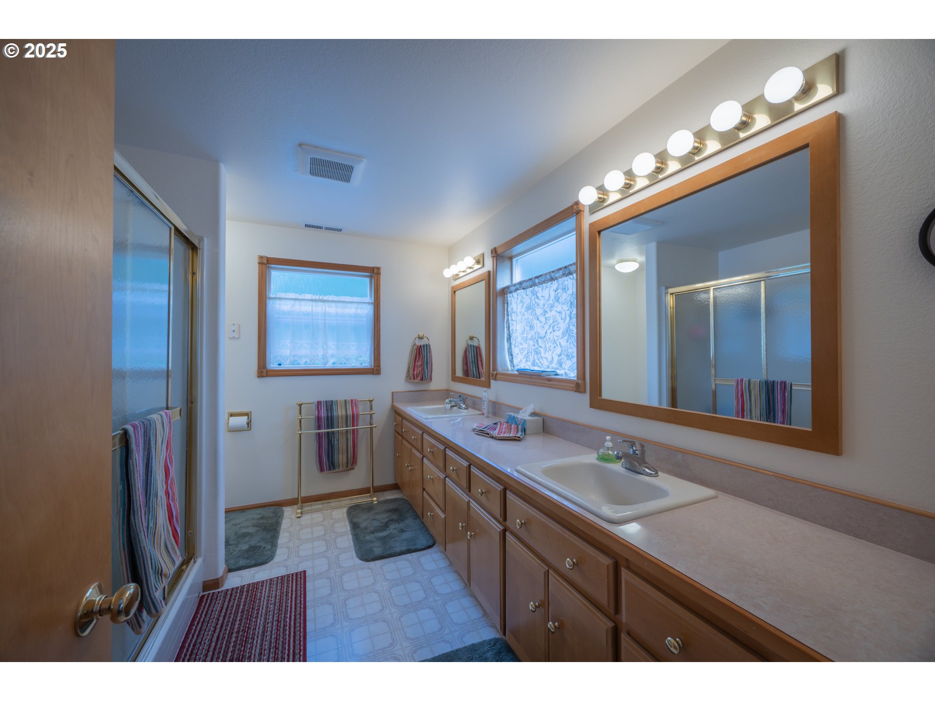 2184 13th Street Florence, OR 97439 - Photo 24 of 44 a bathroom with a sink a large mirror and a shower