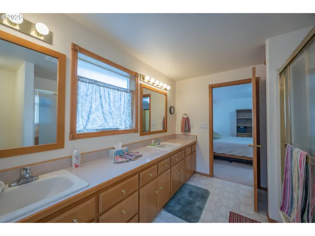 a bathroom with a granite countertop sink mirror and double