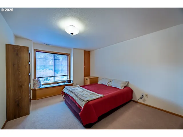 a living room with a bed furniture and a window