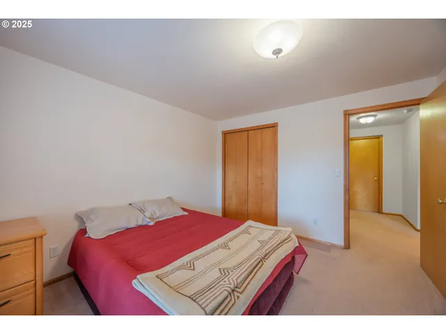 a bedroom with a bed and a dresser