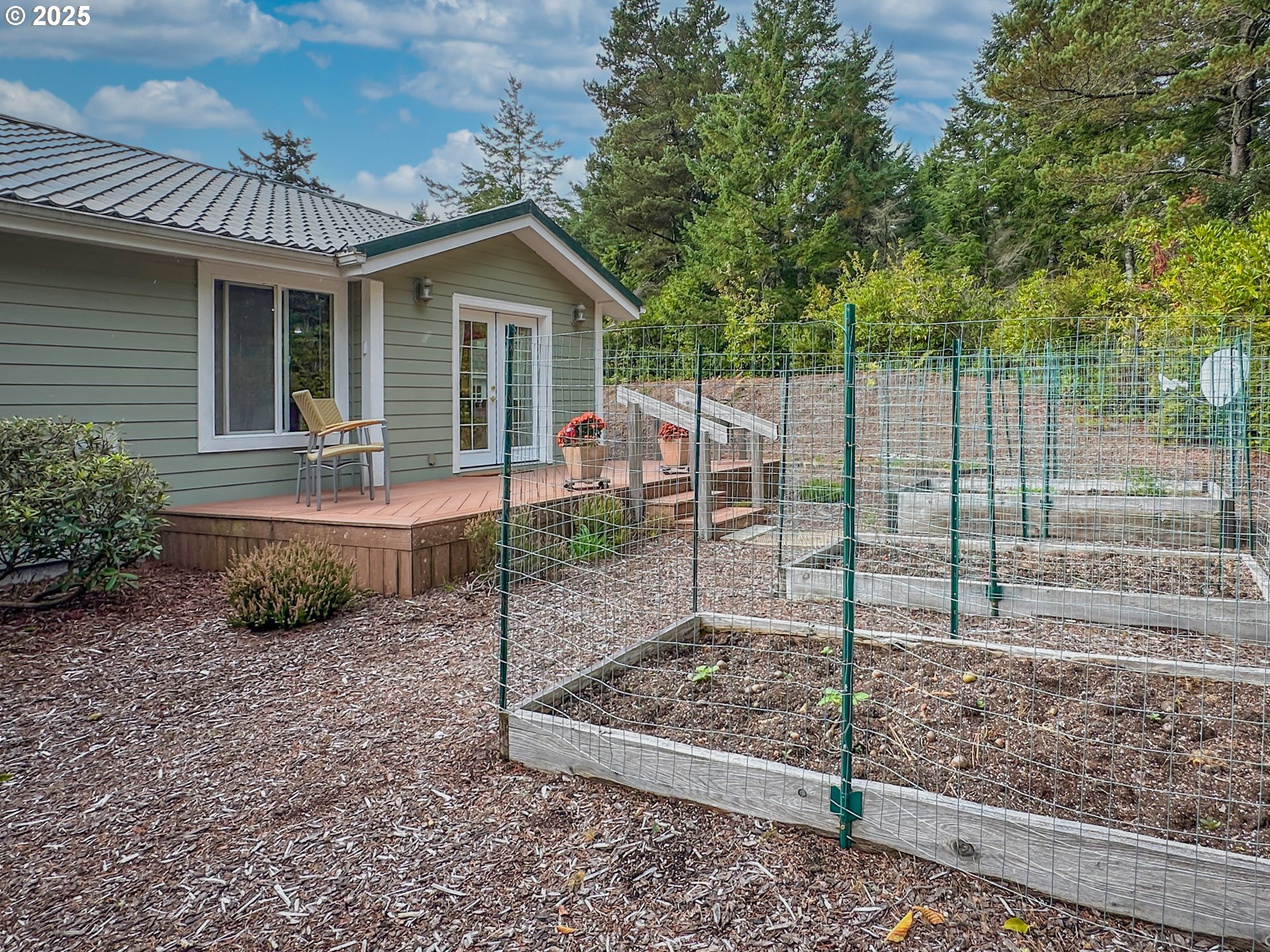 2184 13th Street Florence, OR 97439 - Photo 35 of 44 a view of a house with a backyard