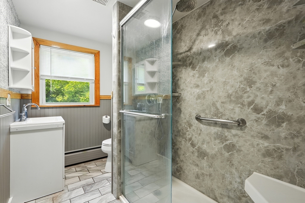 158 Chudy Street Three Rivers, MA 01080 - Photo 31 of 42 a bathroom with a granite countertop sink a toilet and a shower