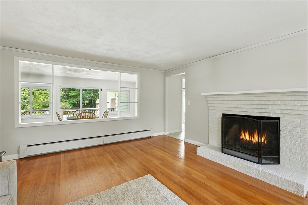 158 Chudy Street Three Rivers, MA 01080 - Photo 10 of 42 a living room with a fireplace with wooden floor