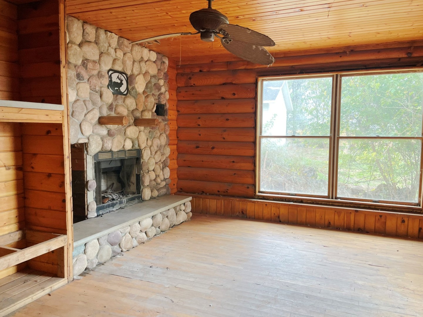 2793 Stone Quarry Road Belvidere, IL 61008 - Photo 3 of 16 a view of an empty room with a fireplace and a window