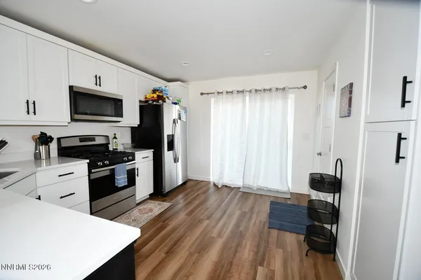 a kitchen with a refrigerator stove and white cabinets
