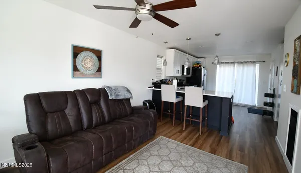 a living room with furniture kitchen view and a dining table
