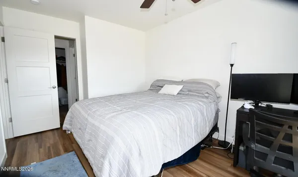 a bedroom with a bed and flat screen tv