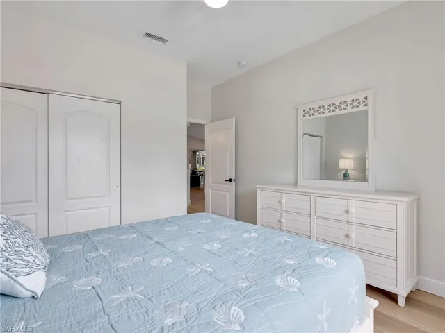 a bedroom with a bed and a mirror