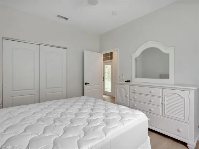 a bedroom with a bed and a closet