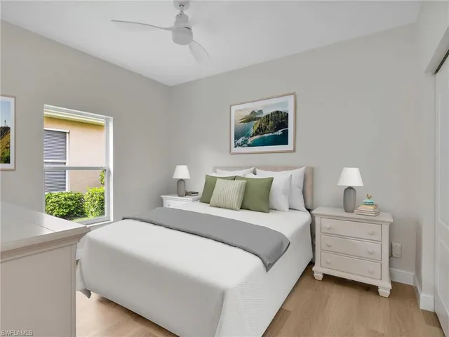 a bedroom with a bed and a painting on the wall